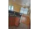 Open kitchen area with laminate flooring, double sink, and eat-in dining space at 506 Myakka Pl, Kissimmee, FL 34759