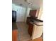 Practical kitchen with tile floors, wooden cabinets, and standard appliances at 506 Myakka Pl, Kissimmee, FL 34759