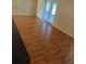 Open-concept living area with laminate flooring and sliding glass doors to the backyard at 506 Myakka Pl, Kissimmee, FL 34759