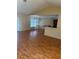 Bright living area with laminate floors, offering a view of the kitchen and backyard at 506 Myakka Pl, Kissimmee, FL 34759