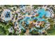 Aerial view of the community resort style swimming pool and lazy river, complete with palm trees and lounge chairs at 7848 Somersworth Dr, Kissimmee, FL 34747