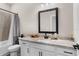 Bathroom featuring a granite countertop vanity, white cabinets, and a shower-tub combination with tile surround at 7848 Somersworth Dr, Kissimmee, FL 34747