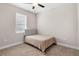 Comfortable bedroom featuring neutral carpet, a soft bed, a window with blinds, and a ceiling fan at 7848 Somersworth Dr, Kissimmee, FL 34747