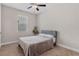 Neutral bedroom featuring a comfortable bed, soft carpet, a window with blinds, and a ceiling fan at 7848 Somersworth Dr, Kissimmee, FL 34747