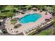 Inviting community pool surrounded by lounge chairs, tables, and lush landscaping at 7848 Somersworth Dr, Kissimmee, FL 34747
