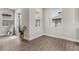 Bright entryway with wood-look floors, a large mirror, a plant, and plenty of natural light at 7848 Somersworth Dr, Kissimmee, FL 34747