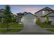 Charming single-Gathering home featuring a two-car garage, stone accents, and a well-manicured lawn in a suburban neighborhood at 7848 Somersworth Dr, Kissimmee, FL 34747