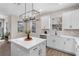 Lovely kitchen featuring a large white island, bright windows, stainless steel appliances, and neutral color palette at 7848 Somersworth Dr, Kissimmee, FL 34747