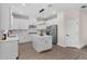 Modern kitchen boasting white cabinetry, stainless steel appliances, an island, and hardwood floors for a stylish cooking space at 7848 Somersworth Dr, Kissimmee, FL 34747
