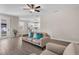 Inviting living room with hardwood floors, a comfortable sofa, and an open layout that flows into the kitchen area at 7848 Somersworth Dr, Kissimmee, FL 34747