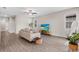 Bright living room featuring wood-look floors, a ceiling fan, and neutral decor, creating a modern and inviting space at 7848 Somersworth Dr, Kissimmee, FL 34747