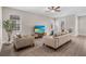Open-concept living room showcasing neutral furniture, natural light, and modern finishes for a welcoming atmosphere at 7848 Somersworth Dr, Kissimmee, FL 34747