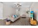 Spacious living room with stylish decor, including a comfortable sofa, accent chair, and modern entertainment center at 7848 Somersworth Dr, Kissimmee, FL 34747