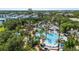 Aerial view of an expansive water park with pools, slides, and tropical landscaping at 7848 Somersworth Dr, Kissimmee, FL 34747