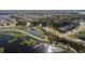 Scenic aerial shot of the community with lake, walkways, and attractive homes nestled among lush landscaping at 1456 Sourwood Dr, Ocoee, FL 34761