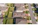 Aerial view of back of home and backyard with green lawn, partial fence, and neighboring rooftops at 1456 Sourwood Dr, Ocoee, FL 34761