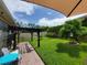 Well-maintained backyard featuring a pergola with string lights, a privacy fence, and ample space for outdoor activities at 1456 Sourwood Dr, Ocoee, FL 34761