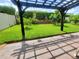 Lush backyard featuring a pergola-covered patio, mature trees, and well-kept landscaping, creating a peaceful outdoor oasis at 1456 Sourwood Dr, Ocoee, FL 34761