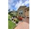 Charming single-Gathering home with a stone facade and well-maintained landscaping with vibrant flowers at 1456 Sourwood Dr, Ocoee, FL 34761