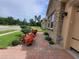 Inviting walkway to a single-Gathering home showcasing stone accents, well-maintained landscaping, and lush greenery at 1456 Sourwood Dr, Ocoee, FL 34761