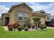 Charming single-Gathering home featuring a stone facade with manicured landscaping and a well-kept lawn at 1456 Sourwood Dr, Ocoee, FL 34761