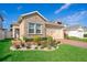 Charming single-Gathering home featuring a stone facade and meticulously landscaped front yard with vibrant greenery at 1456 Sourwood Dr, Ocoee, FL 34761