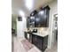Modern kitchen featuring sleek dark cabinets, granite countertops, and stainless steel appliances at 1456 Sourwood Dr, Ocoee, FL 34761