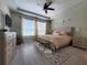 Serene main bedroom with a tray ceiling, plush carpeting, and large windows, offering a relaxing retreat at 1456 Sourwood Dr, Ocoee, FL 34761