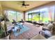 Inviting screened-in patio featuring comfortable seating, a ceiling fan, and a view of the backyard at 1456 Sourwood Dr, Ocoee, FL 34761