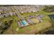 Aerial view showcasing the community pool, clubhouse, and well-maintained green spaces for leisure and recreation at 1456 Sourwood Dr, Ocoee, FL 34761