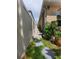 Narrow side yard with a stone pathway, a privacy fence, and landscape lighting, adding charm and functionality at 1456 Sourwood Dr, Ocoee, FL 34761