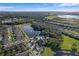Expansive aerial view of a well-planned community featuring a central lake and community pool surrounded by lush greenery at 1940 Banner Ln, St Cloud, FL 34769