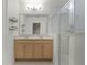 Bathroom features a double vanity with a large mirror, wood floating shelves, and a glass door shower at 1940 Banner Ln, St Cloud, FL 34769