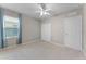 Cozy bedroom featuring a ceiling fan, window with curtains, and closet at 1940 Banner Ln, St Cloud, FL 34769