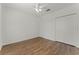 Open bedroom with wood floors, ceiling fan, and a closet at 1940 Banner Ln, St Cloud, FL 34769