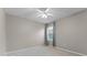 Neutral bedroom with a ceiling fan and a window for natural light at 1940 Banner Ln, St Cloud, FL 34769