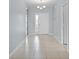 Bright and airy foyer featuring tile flooring, a front door with sidelight, and neutral paint at 1940 Banner Ln, St Cloud, FL 34769
