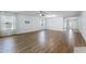 Expansive living room featuring hardwood floors, large windows, and modern lighting at 1940 Banner Ln, St Cloud, FL 34769