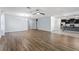 Spacious living room with hardwood floors, a ceiling fan, and ample natural light at 1940 Banner Ln, St Cloud, FL 34769