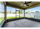 This screened in patio features a ceiling fan and backyard views at 1940 Banner Ln, St Cloud, FL 34769
