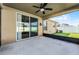 This patio features a ceiling fan and sliding glass doors leading to the backyard at 1940 Banner Ln, St Cloud, FL 34769