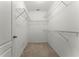 Spacious walk-in closet with carpet and multiple wire rack shelving units, great for closet organization at 1940 Banner Ln, St Cloud, FL 34769