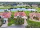 An aerial shot showcases the home's prime location near a pond, landscaping, and neighborhood at 324 Sorrento Rd, Poinciana, FL 34759