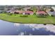 Expansive aerial view of homes with screened lanais along a pond offering scenic views at 324 Sorrento Rd, Poinciana, FL 34759