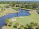 Golf course aerial view, featuring a bridge over a lake, surrounded by lush landscaping at 324 Sorrento Rd, Poinciana, FL 34759