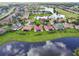 Picturesque aerial view of homes with screened lanais along a pond offering scenic views at 324 Sorrento Rd, Poinciana, FL 34759