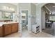 Well-lit bathroom with tile flooring, vanity, separate toilet room, and access to other rooms at 324 Sorrento Rd, Poinciana, FL 34759