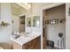 Bright bathroom featuring vanity with white countertop, cabinet, and decorative mirror at 324 Sorrento Rd, Poinciana, FL 34759