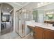 Bright bathroom features a tiled shower with glass enclosure, and a vanity with storage at 324 Sorrento Rd, Poinciana, FL 34759