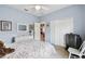 Bedroom featuring a plush bed, dresser with mirror, closet, and neutral carpeting at 324 Sorrento Rd, Poinciana, FL 34759